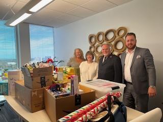 Trial Pro team members with boxes of Angel Tree gifts ready for a local family.