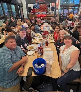 Trial Pro team members gathered around a restaurant table for Kick Off for Kids.
